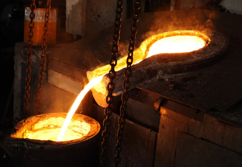 Molten metal being poured into molds at a foundry.