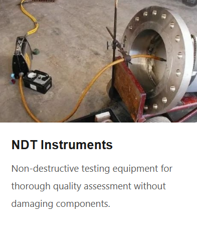 A large metal pipe with a flange, connected to testing equipment including sensors, cables, and a digital device, used for non-destructive testing.