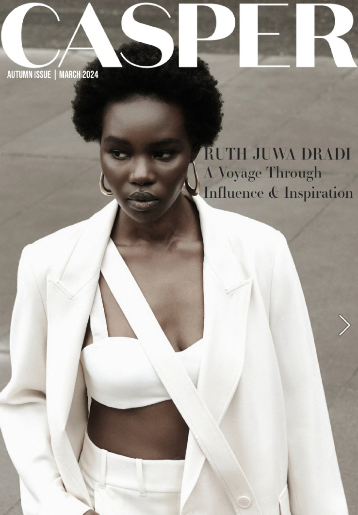 Cover of Casper magazine, March 2024, featuring Ruth Juwa Dradi with natural hair, dark skin, wearing a white blazer over a white crop top and matching pants, standing outdoors on a gray paved surface.