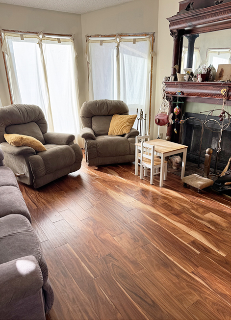 Organized Calgary living room with clear floors and tidy furniture around a fireplace after decluttering.