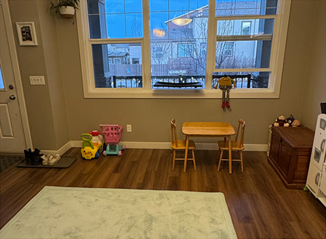 Organized Calgary entryway with a clear kids' table, tidy toy storage, and open floor space after decluttering.