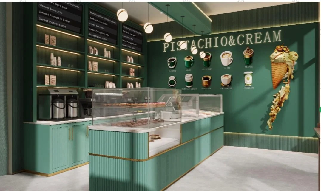 Interior of a shop called Pistachio & Cream, featuring a display counter with ice cream and pizza, a green wall with illustrations of coffee cups and a large ice cream cone, and a menu board listing coffee drinks.