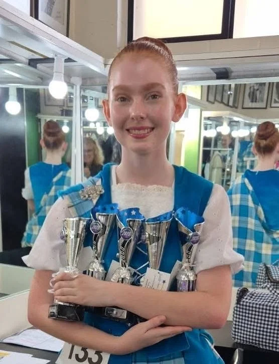 Ruby with trophies.JPG