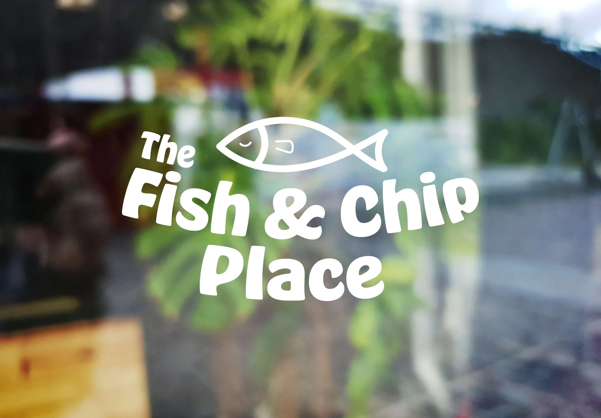 White logo placed on the outside of a restaurant window.