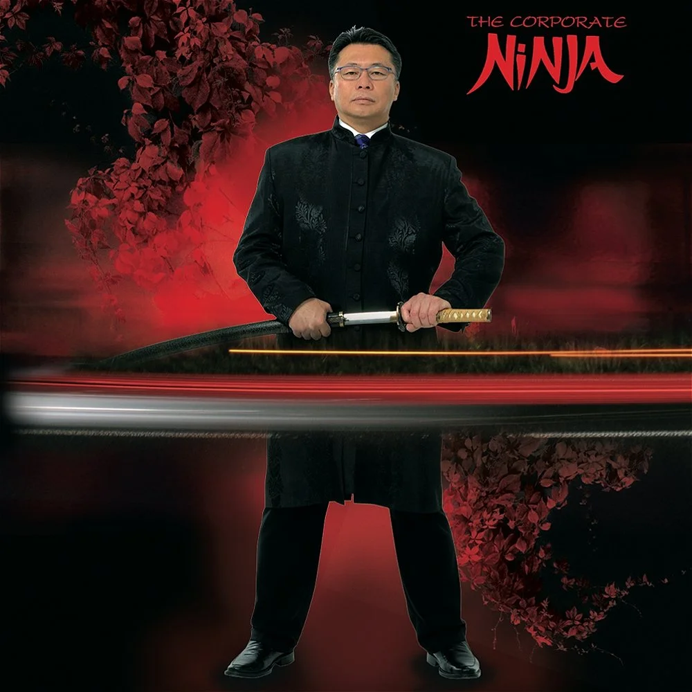 A man in traditional Chinese attire holding a sword, standing in front of a dark red background with red cherry blossoms and the words 'The Corporate Ninja' in the top right corner.