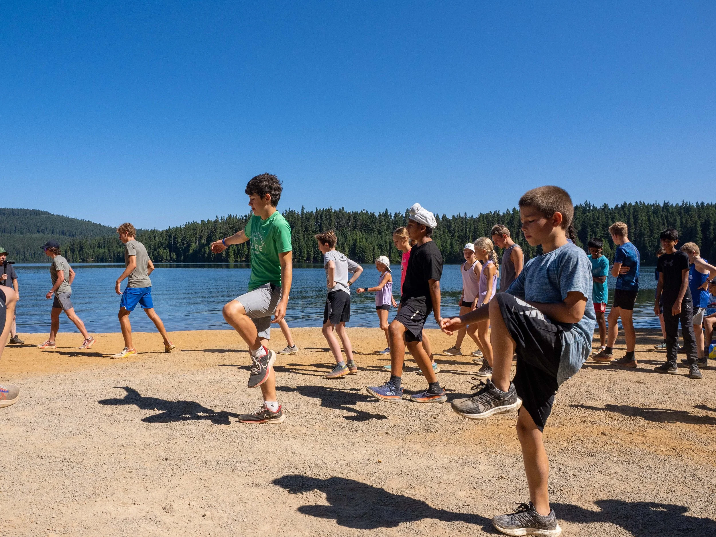Children and teenagers doing a balancing exercise at the Elite Middle School Camp at Youth Runner Camps
