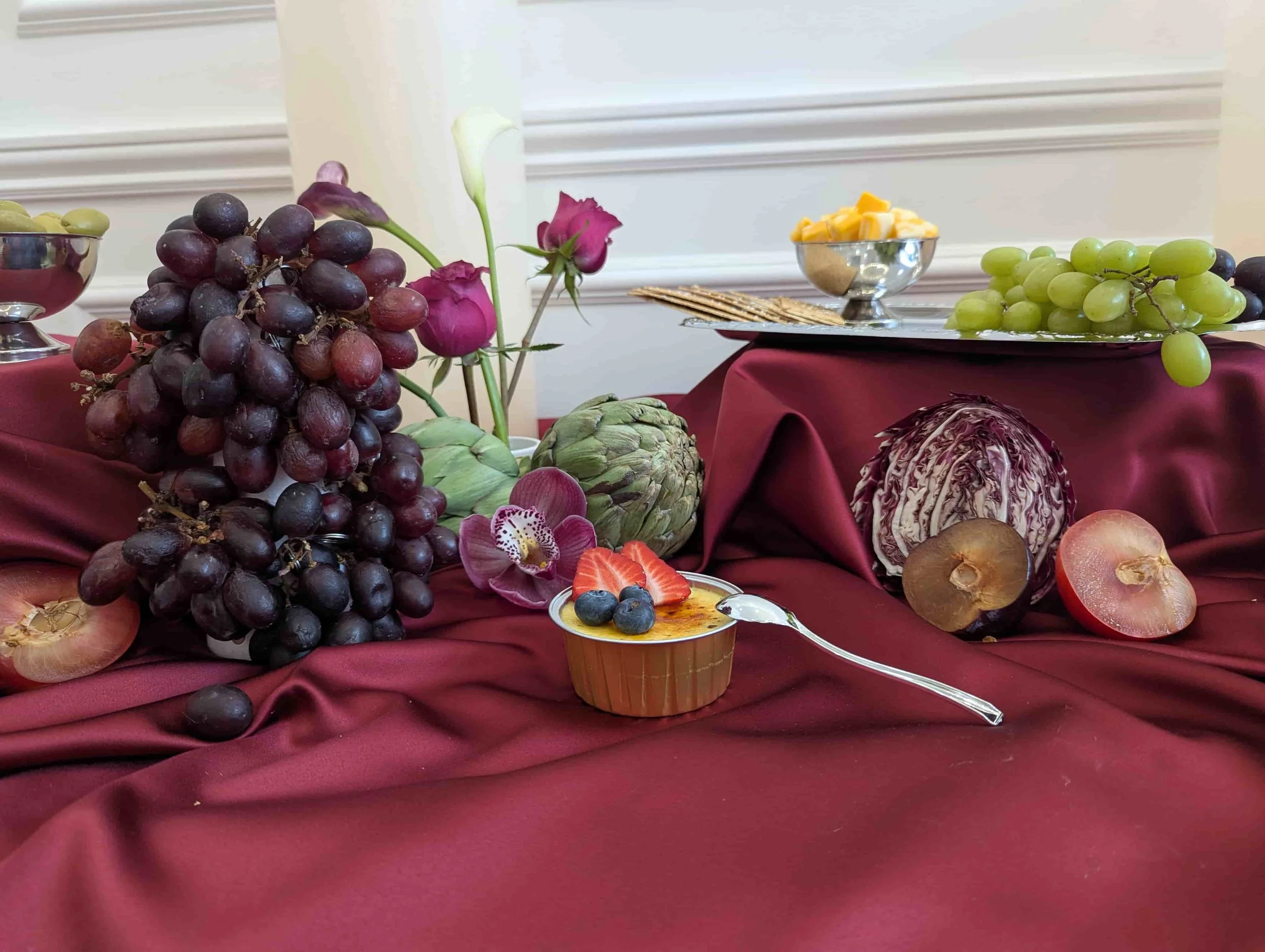 Gourmet crème brûlée wedding dessert bar topped with strawberries and blueberries