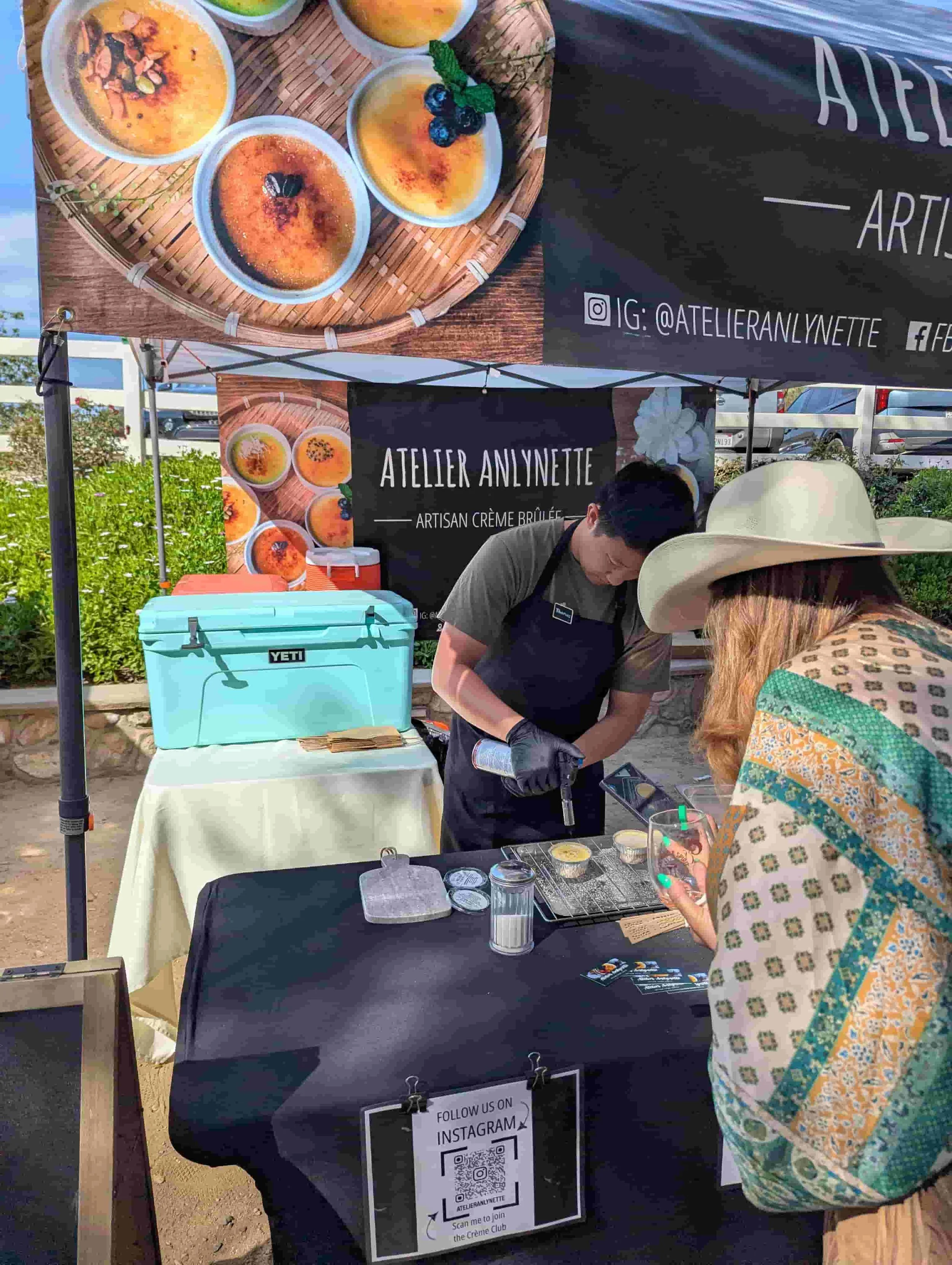 Chef torching crème brûlée at the Atelier Anlynette dessert booth in Orange County
