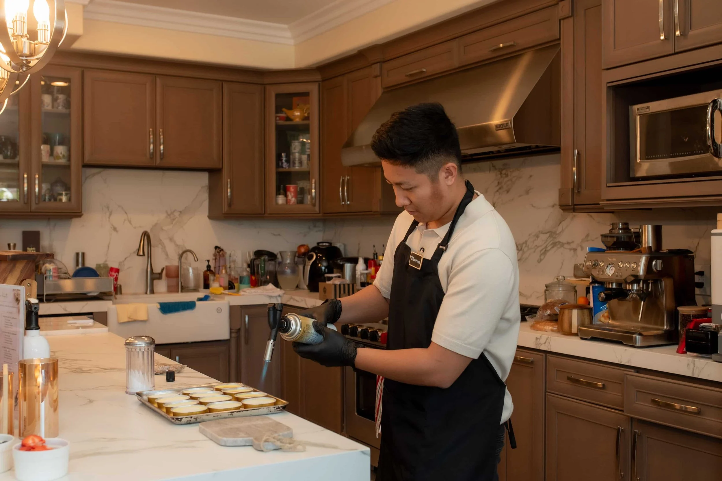 Chef torching crème brûlée caramelized sugar topping for Atelier Anlynette dessert catering