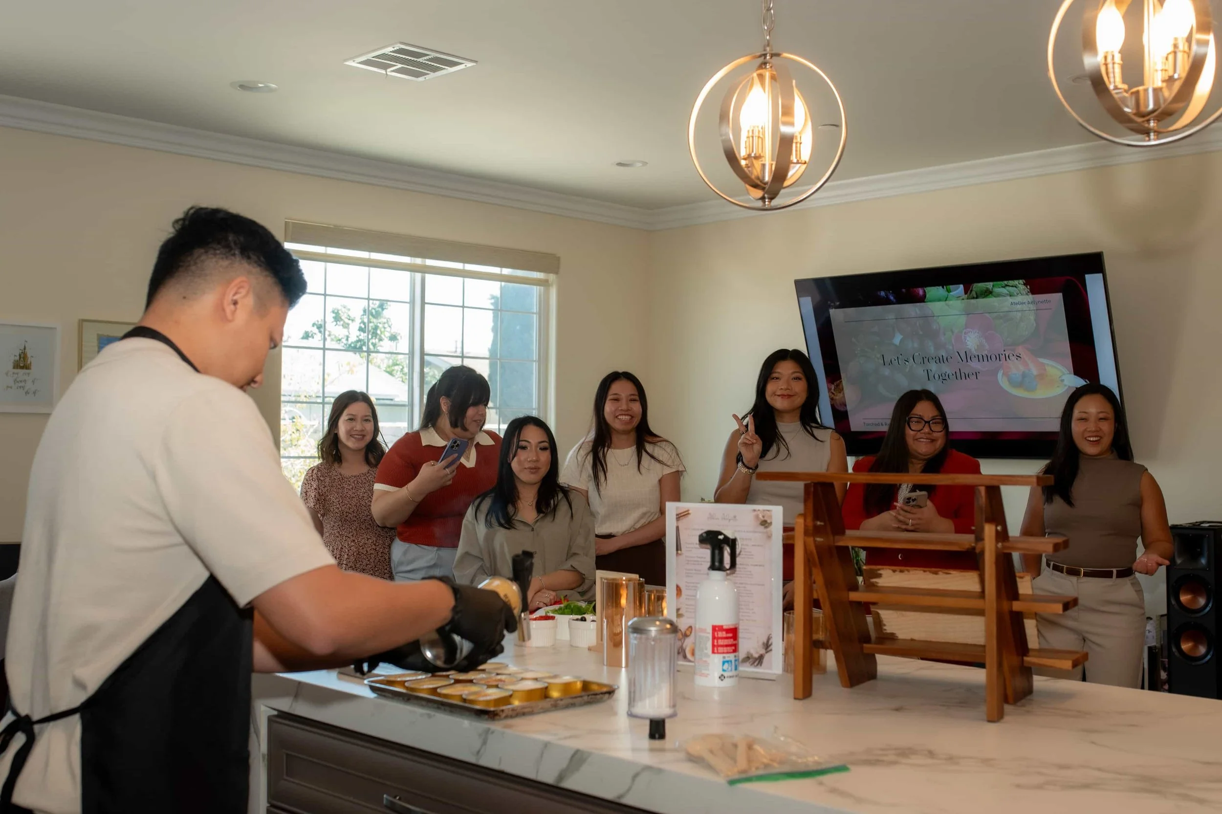 Guests watching a live crème brûlée dessert station at a private event in Orange County