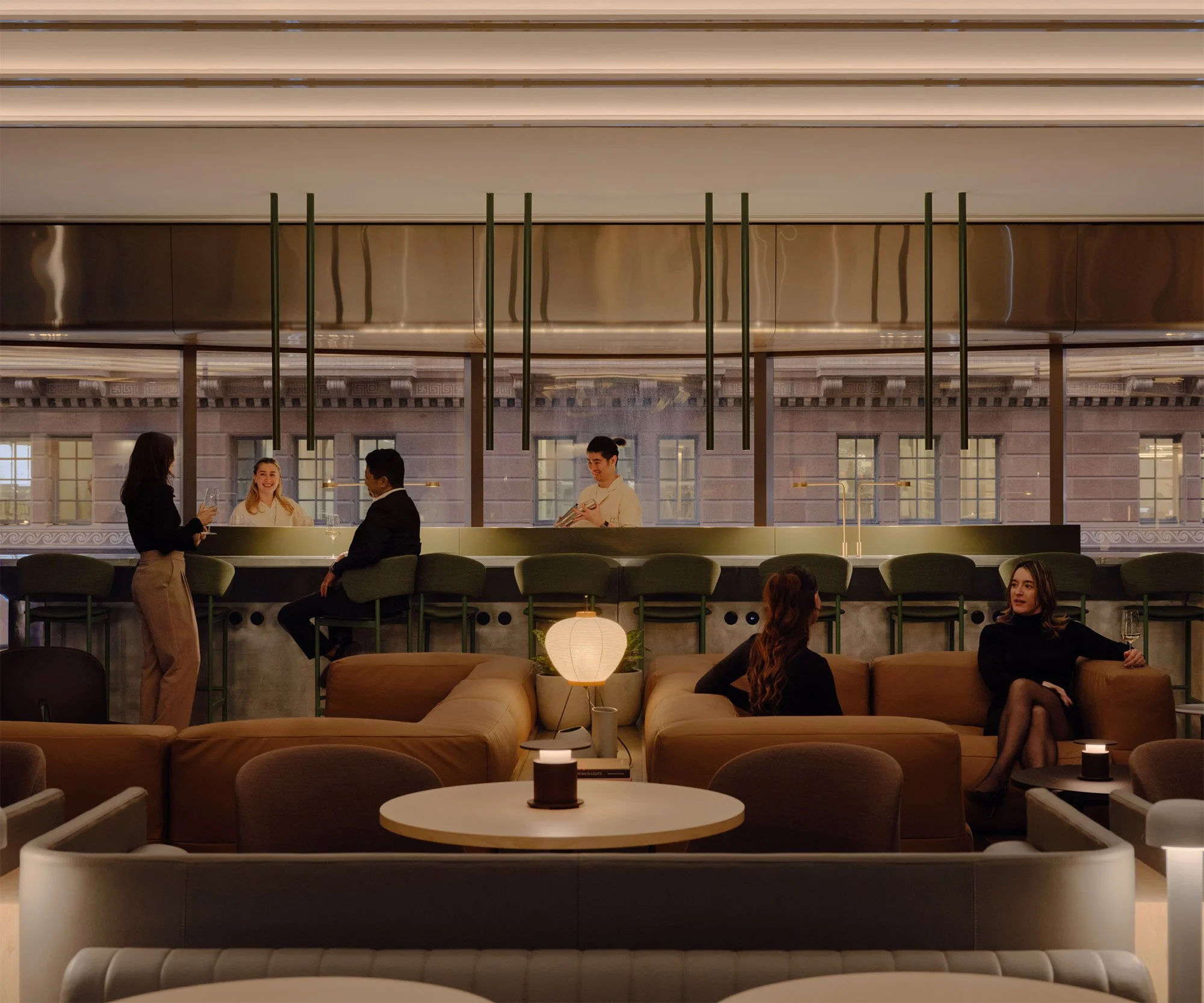 Guests at the bar of a hospitality venue fitted out by Atelis Group