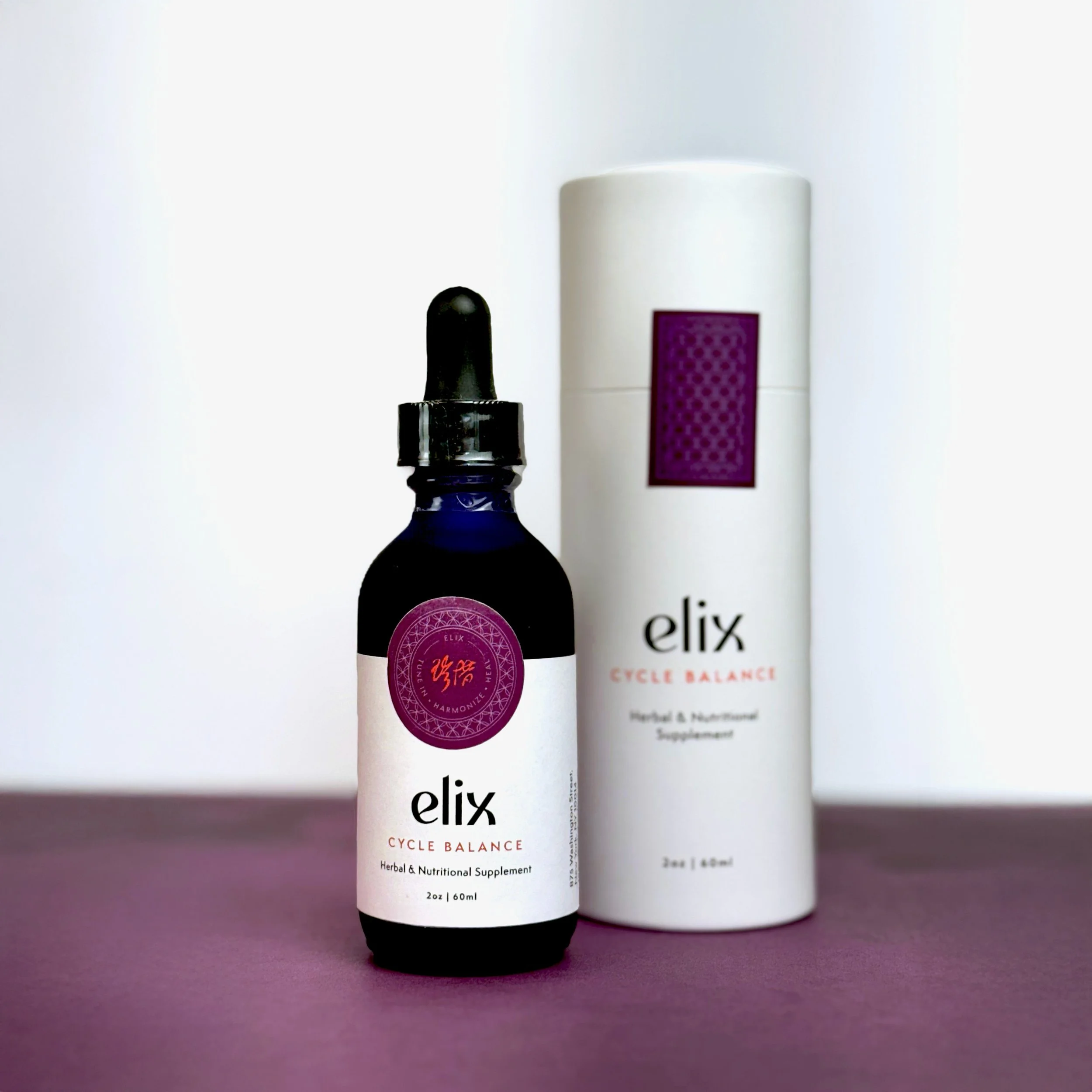 Three bottles of herbal and nutritional supplements with white labels and black caps are displayed against a purple background, with a fourth bottle slightly blurred behind them.