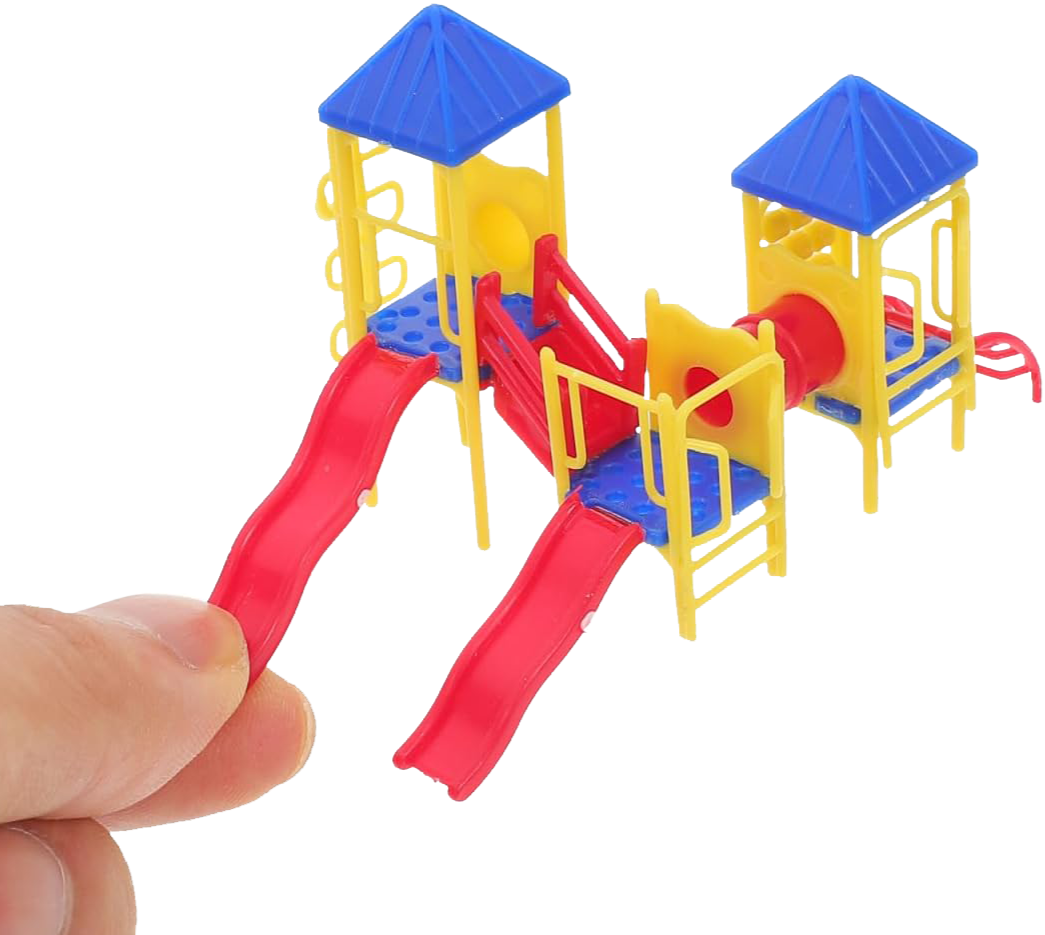 Colorful plastic toy playground with slides and towers in yellow, blue, and red, being held by a person's hand.