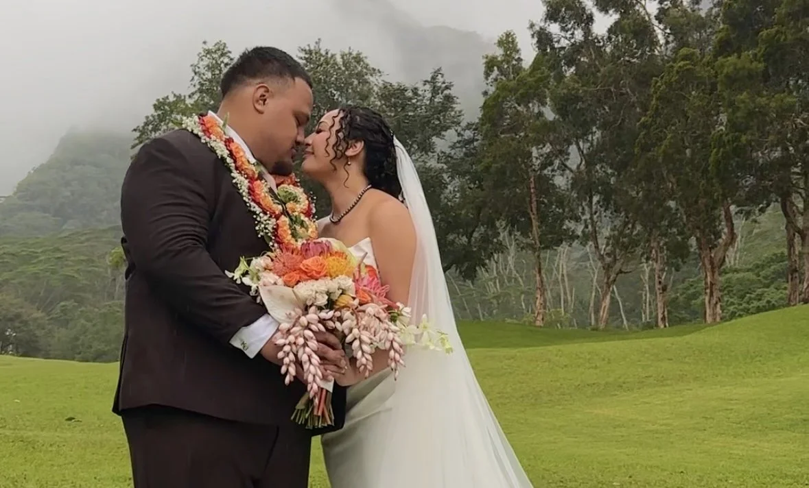 Bride and groom touching noses in intimate romantic portrait at Oahu wedding with soft natural light