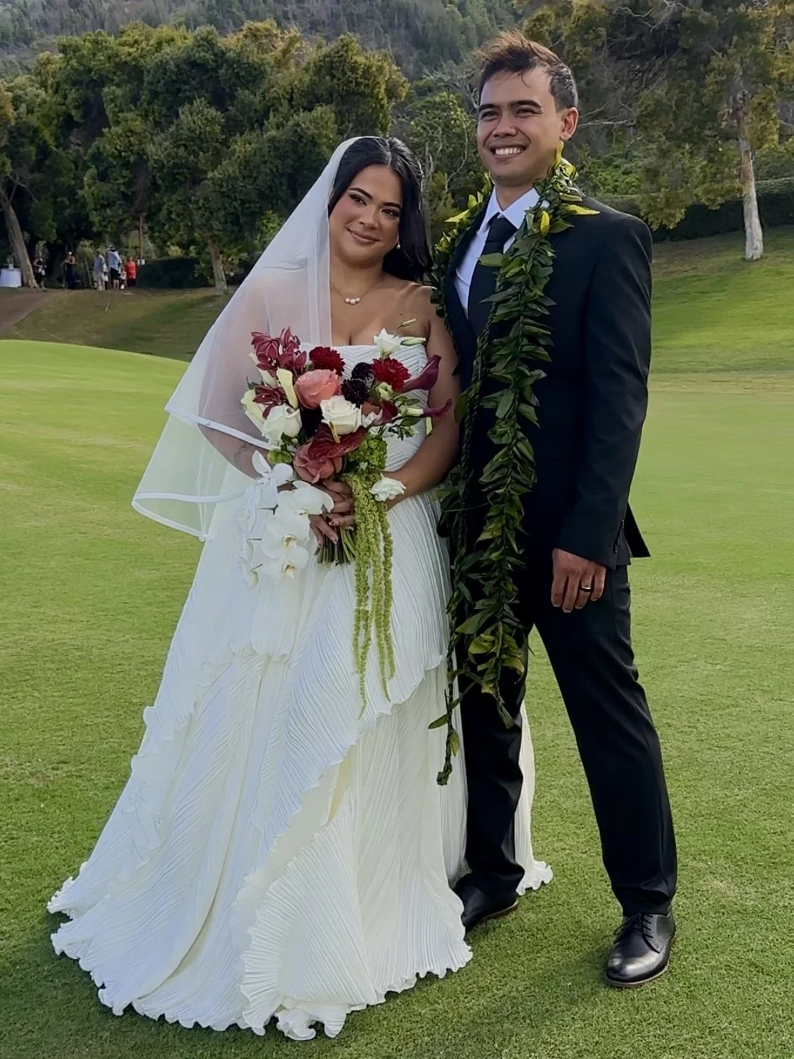 A licensed State of Hawaii wedding officiant reviewing a marriage license with a couple before a wedding ceremony on Maui.