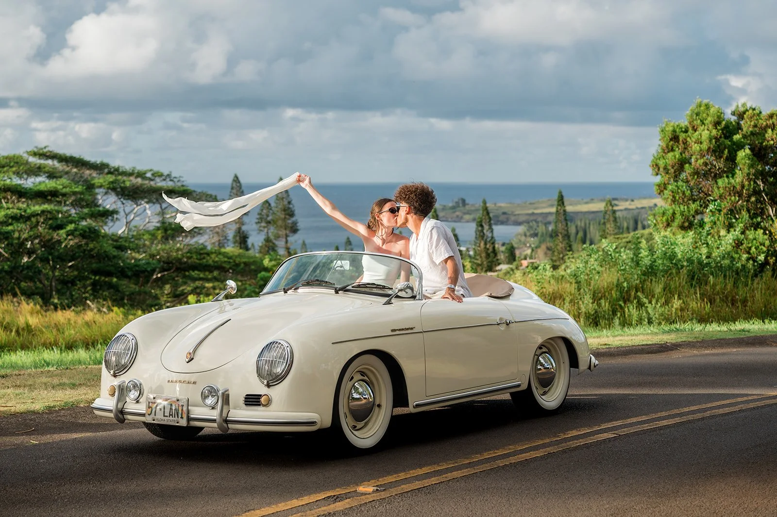 Bride and groom with white 1957 Porsche Speedster at DT Flemings Beach on Maui elopement day