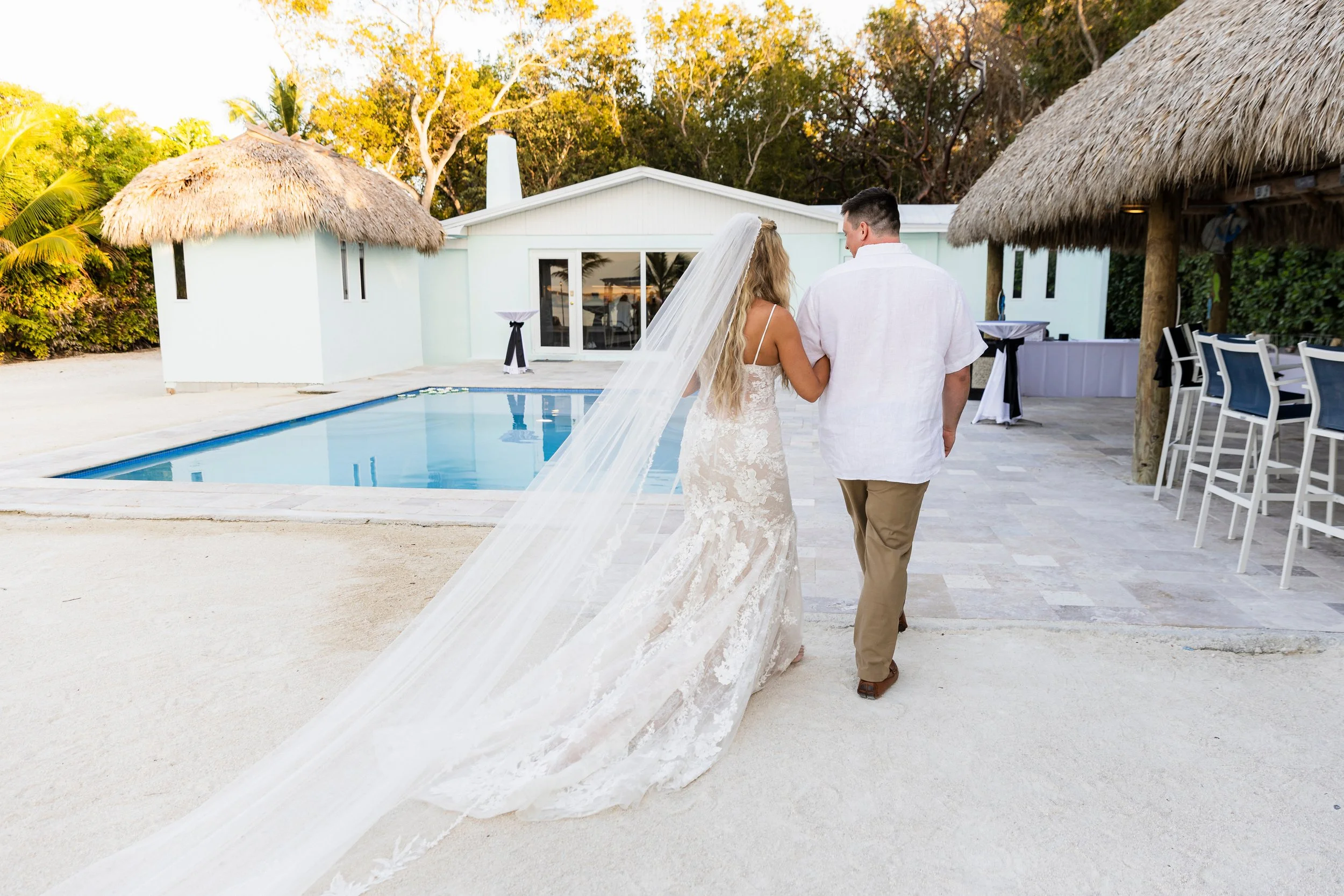 Bride and groom walking into their wedding reception tent at Key Largo Lighthouse Beach Resort