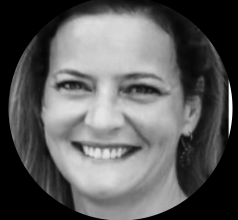 Photo en noir et blanc d'une femme souriante avec des boucles d'oreilles longues.