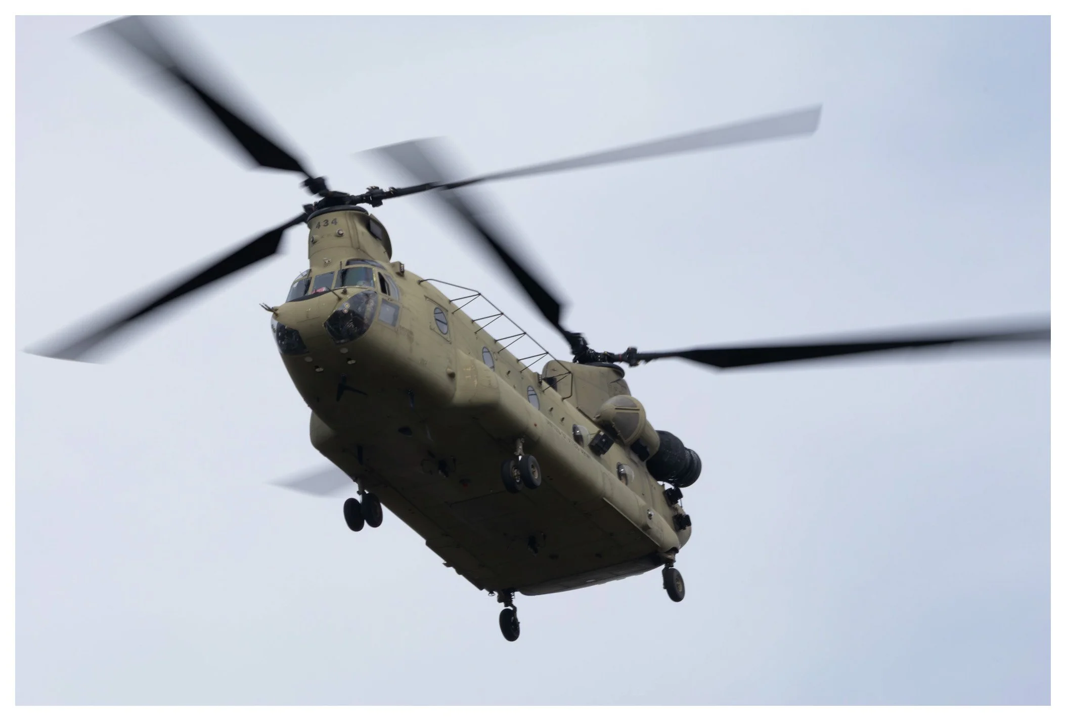 Military helicopter flying in cloudy sky