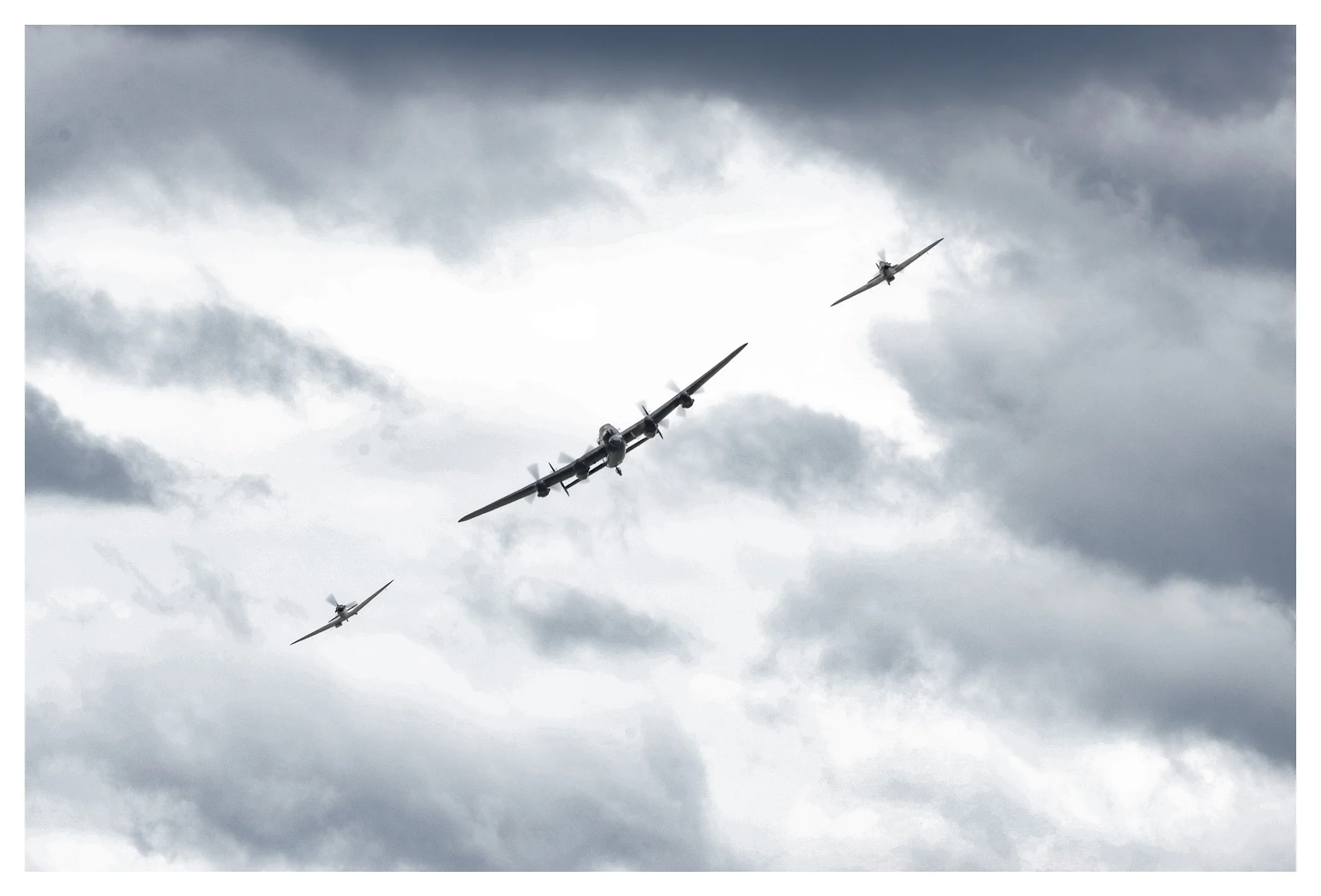 Three vintage military aircraft flying in formation against a cloudy sky.