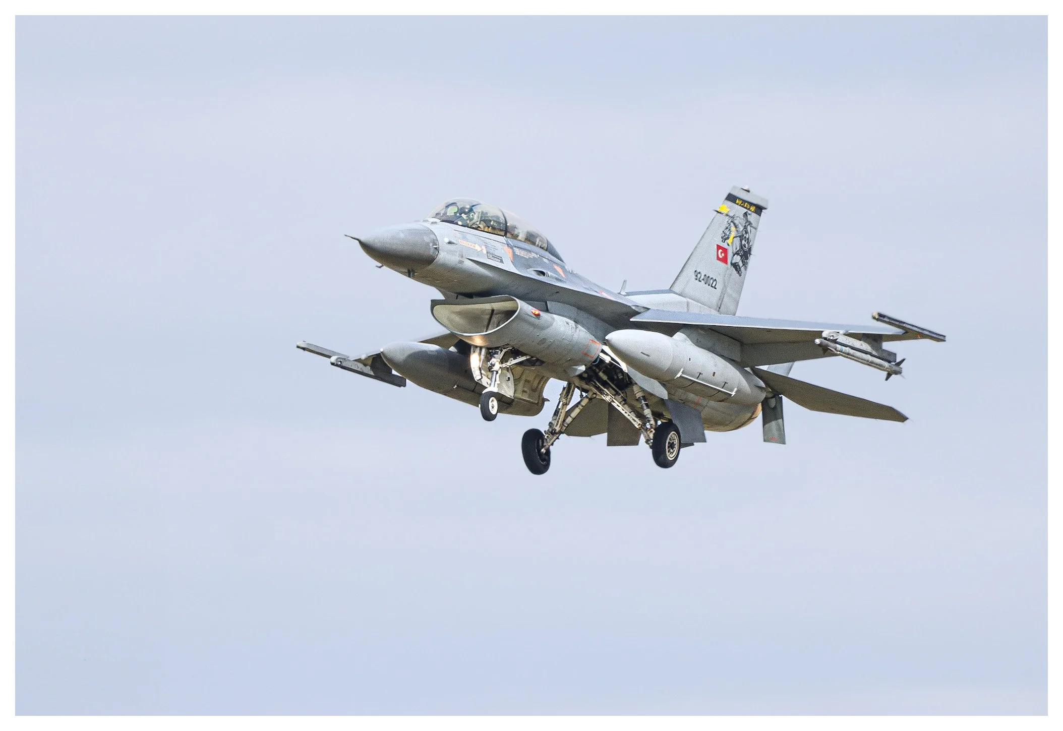 A military fighter jet aircraft flying in the sky.