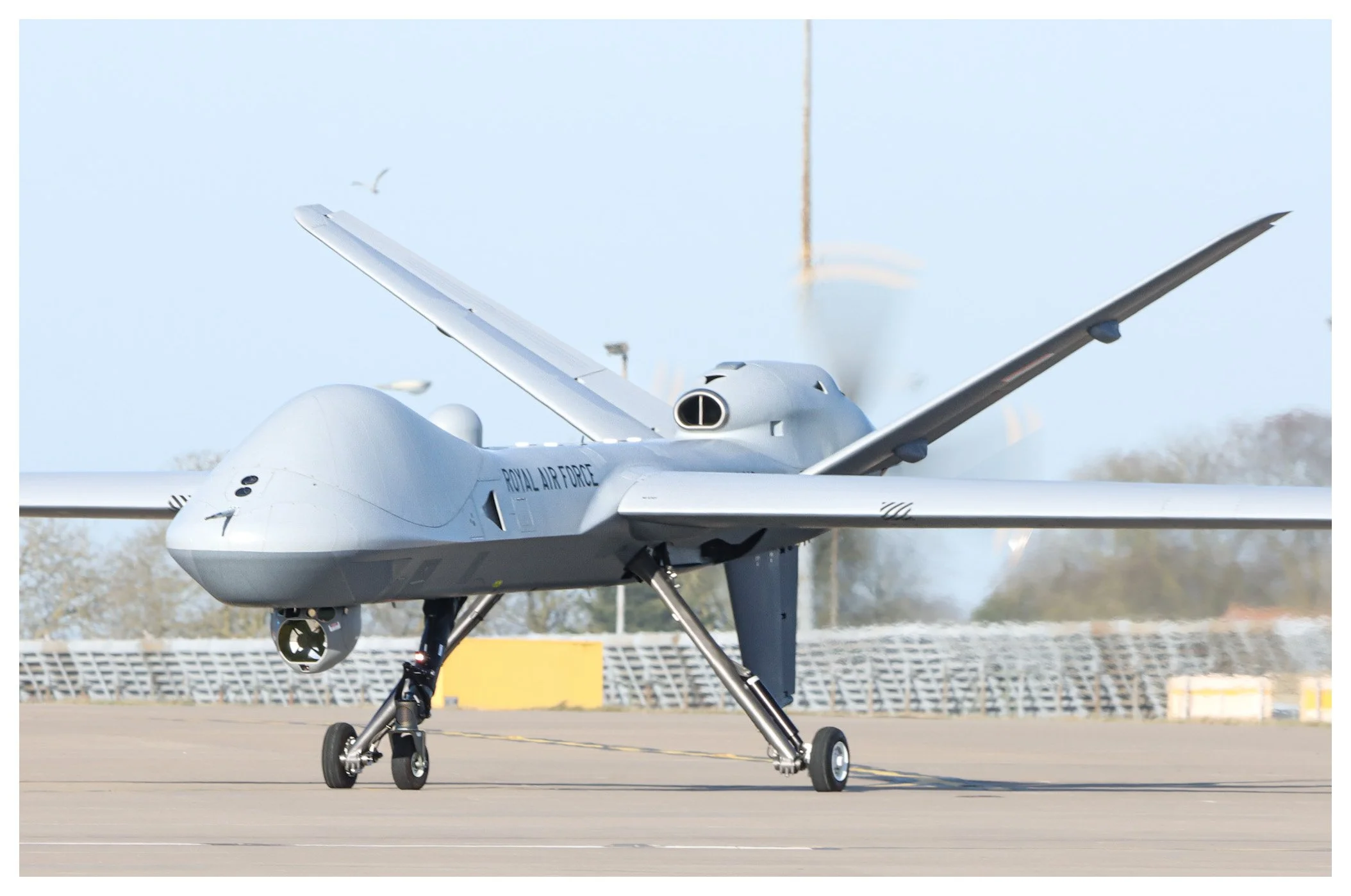 A military drone aircraft on the tarmac, with the words 'Royal Air Force' visible on its body.