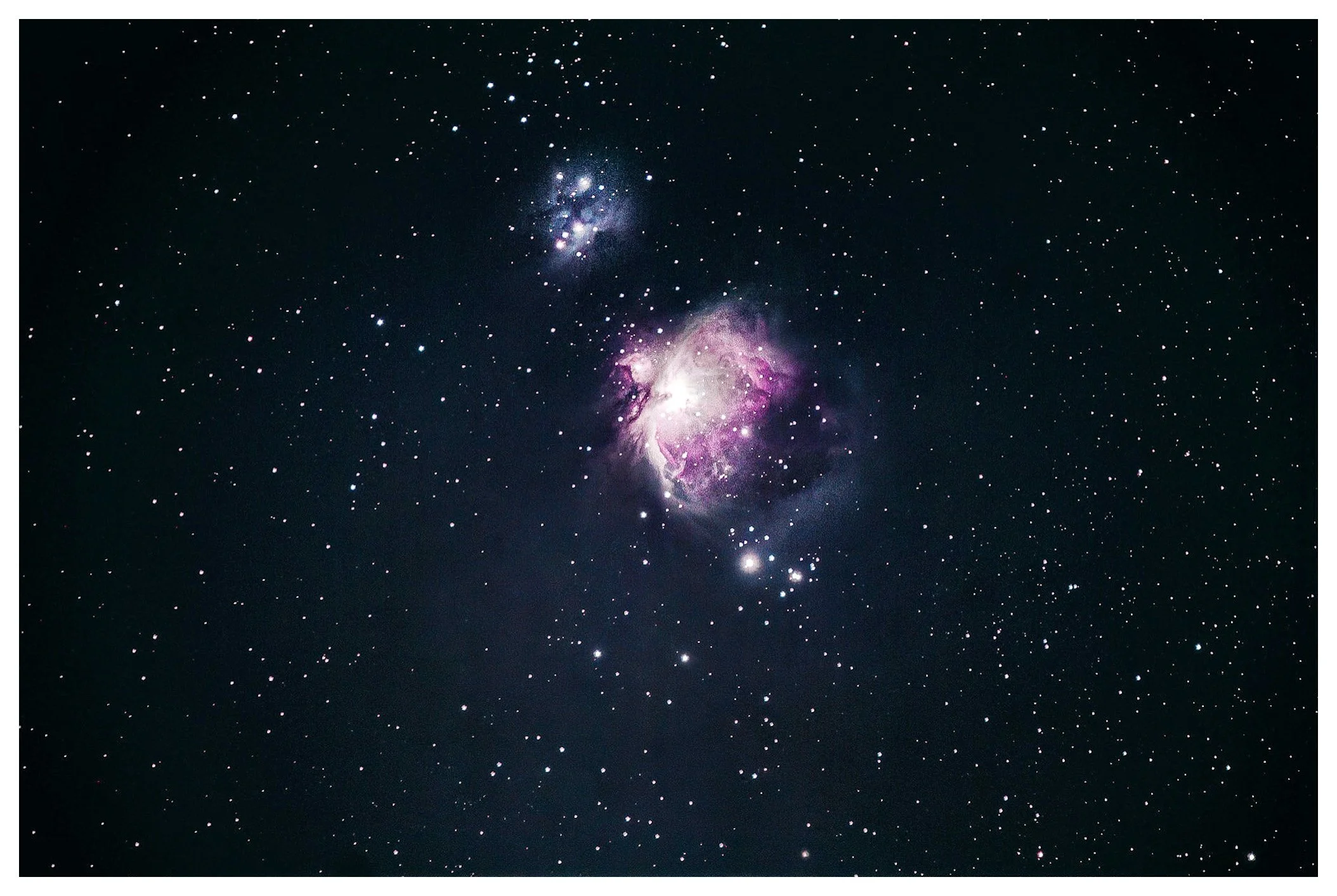 A stunning image of outer space featuring numerous stars, a bright nebula with pink and purple hues, and distant galaxies against a dark background.