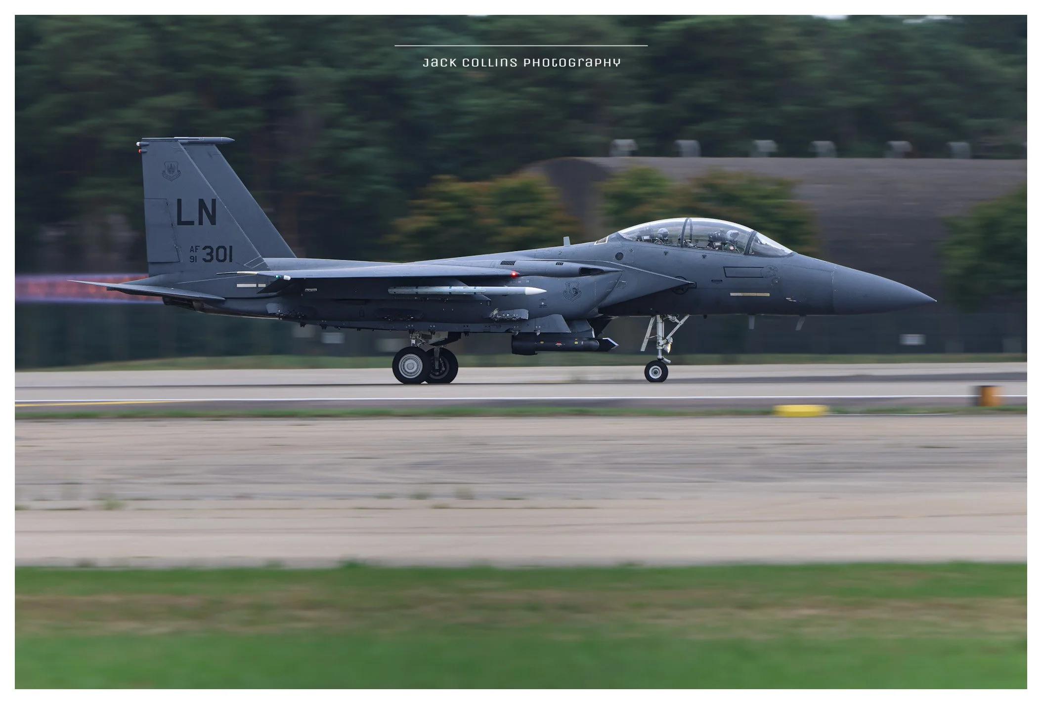 A gray military fighter jet plane on a runway during daytime