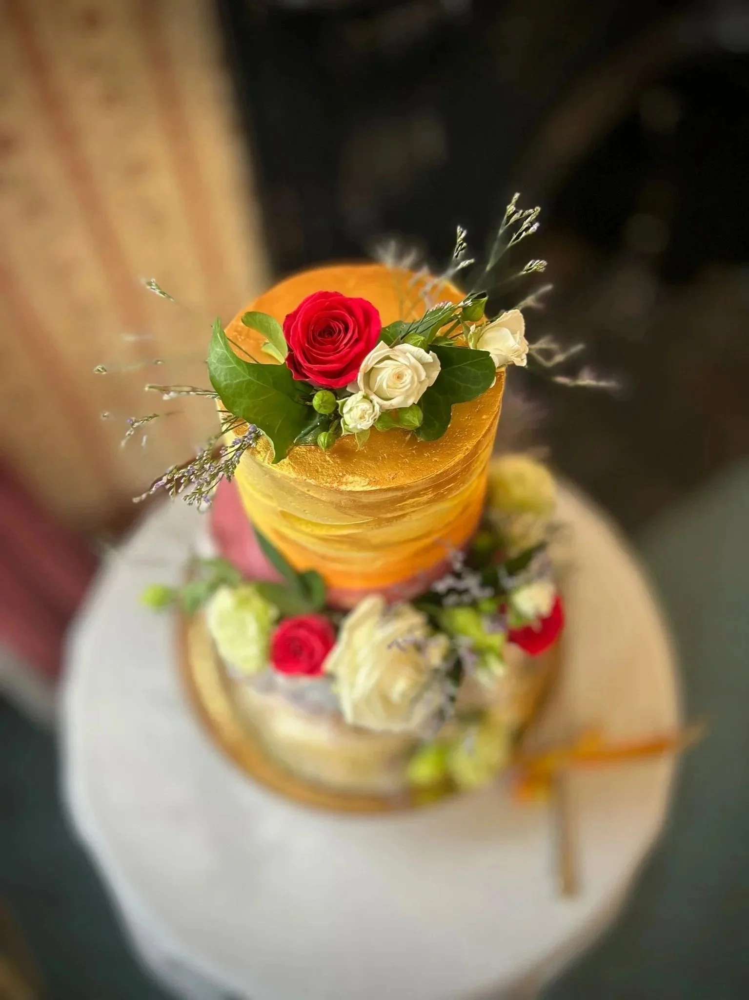 A romantic wedding cake - bottom tier lemon & raspberry with fresh raspberry buttercream conserve filling; top tier - the groom's family sultana cake recipe with marscapone ganache filling. The cake was iced with vanilla Italian meringue buttercream.