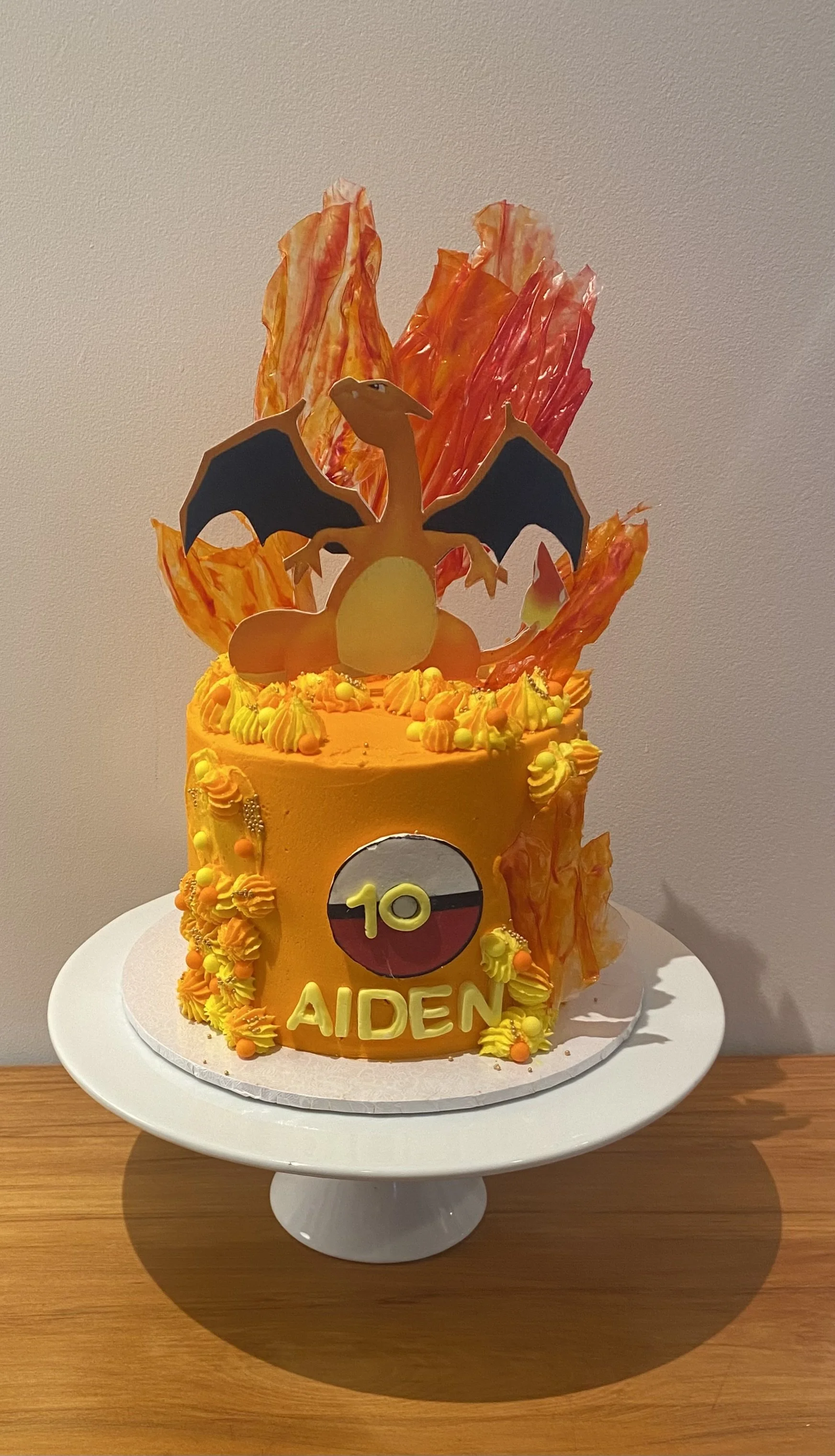 Gluten Free Vanilla Pokemon Charizard cake with American vanilla buttercream, all hand made decorations including rice wafer sails.