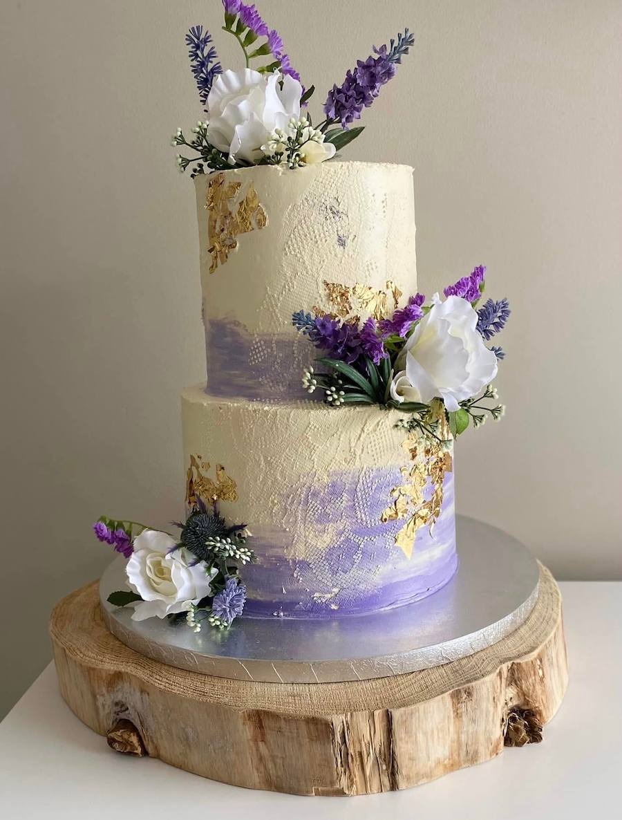 Two tiered wedding cake with lace stencil detailing.