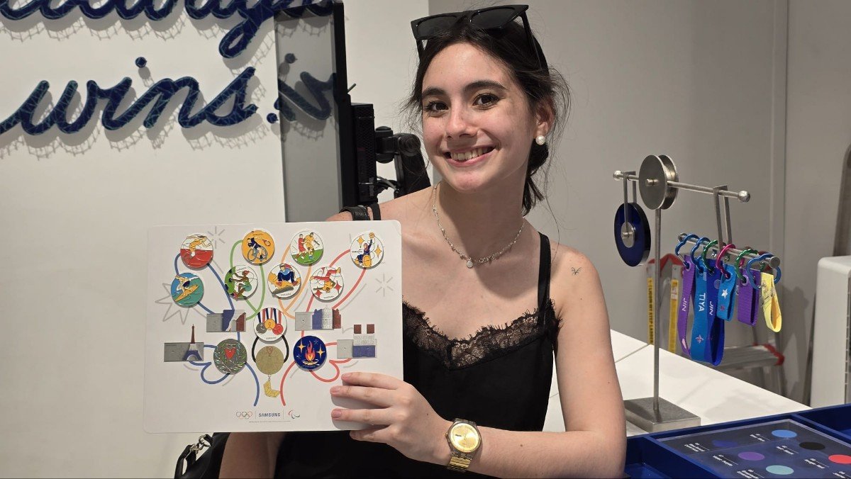 Enthusiastic Participant displaying Samsung Olympic Pin Board Collection at Paris 2024 Event