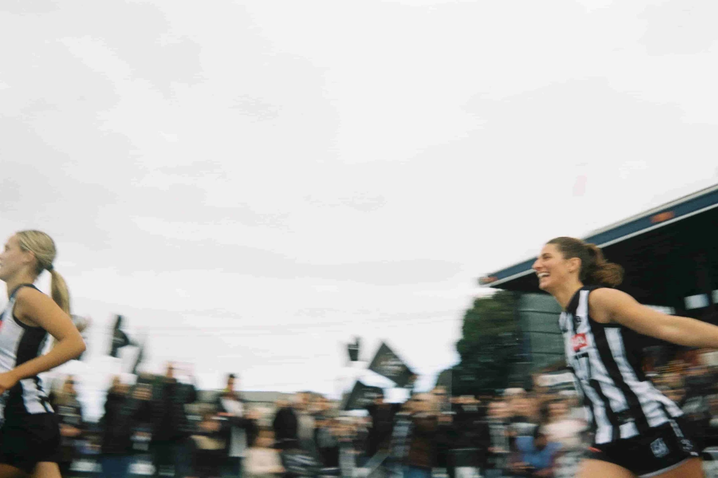 Tayla Christensen running on the field for the VFLW Grand Final for Collingwood