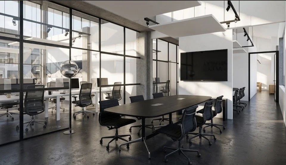 Modern office conference room with black chairs around a black table, large wall-mounted TV, floor-to-ceiling windows, and glass partitions.