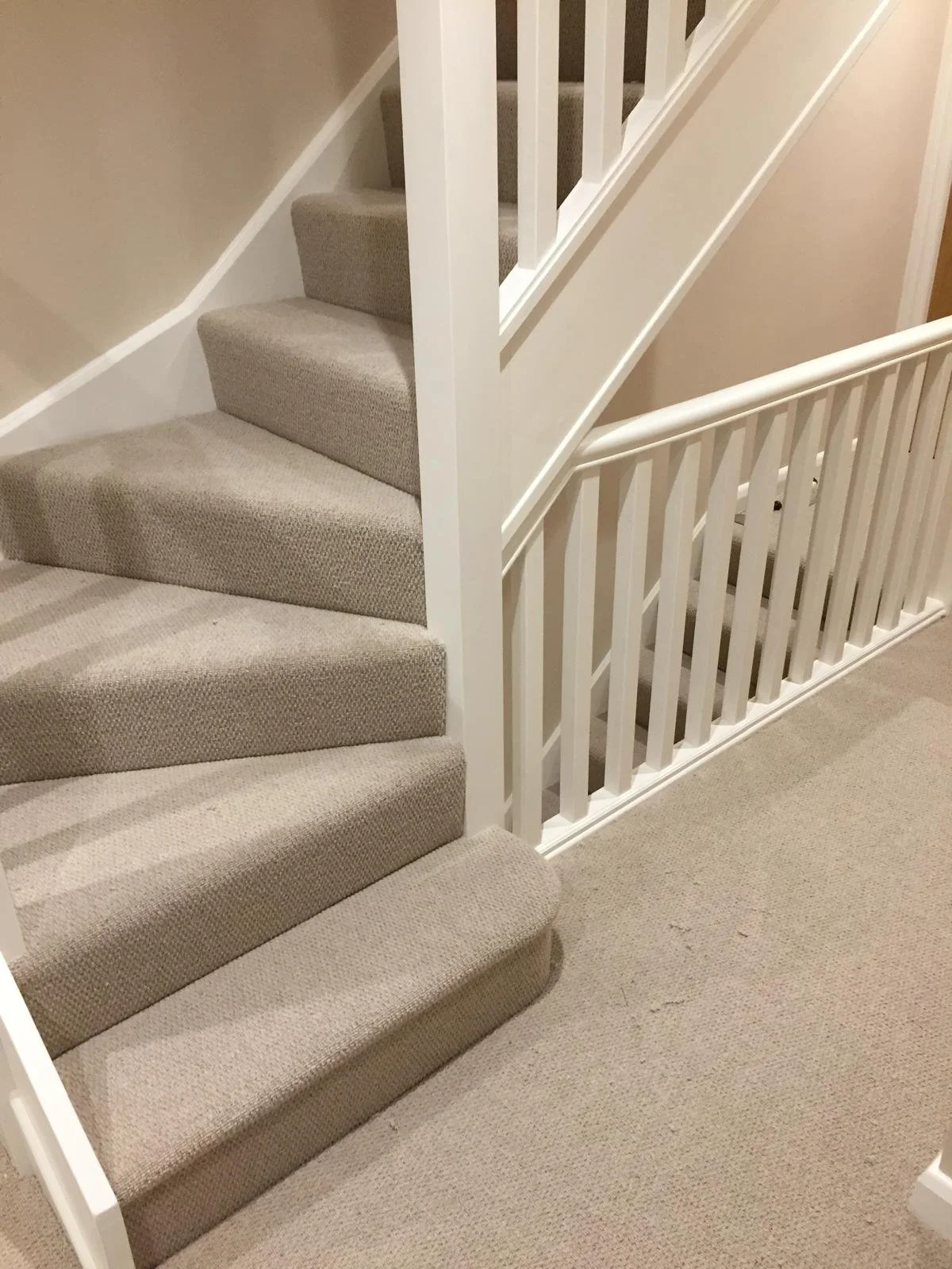 staircase with winders and bullnose carpeted with a natural wool loop pile carpet 