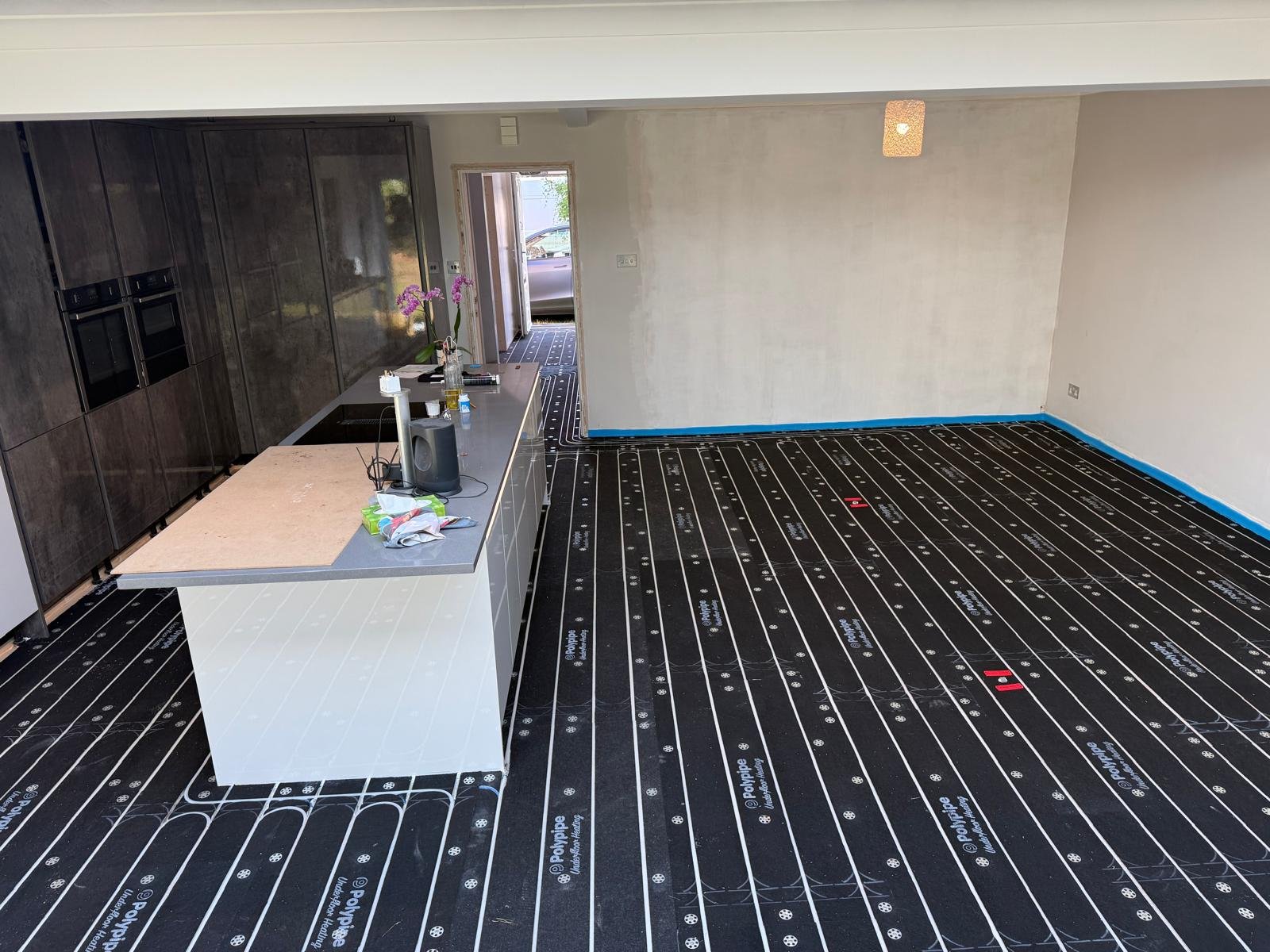 Kitchen diner prepared with water fed Underfloor Heating installed by a plumbing company in preparation for our work.