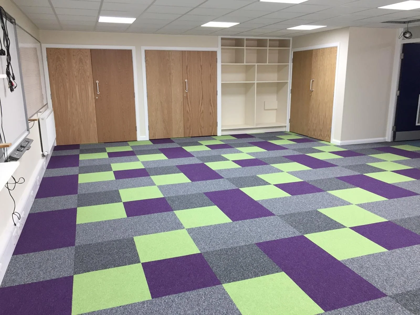 Music room installed with multicoloured carpet tiles