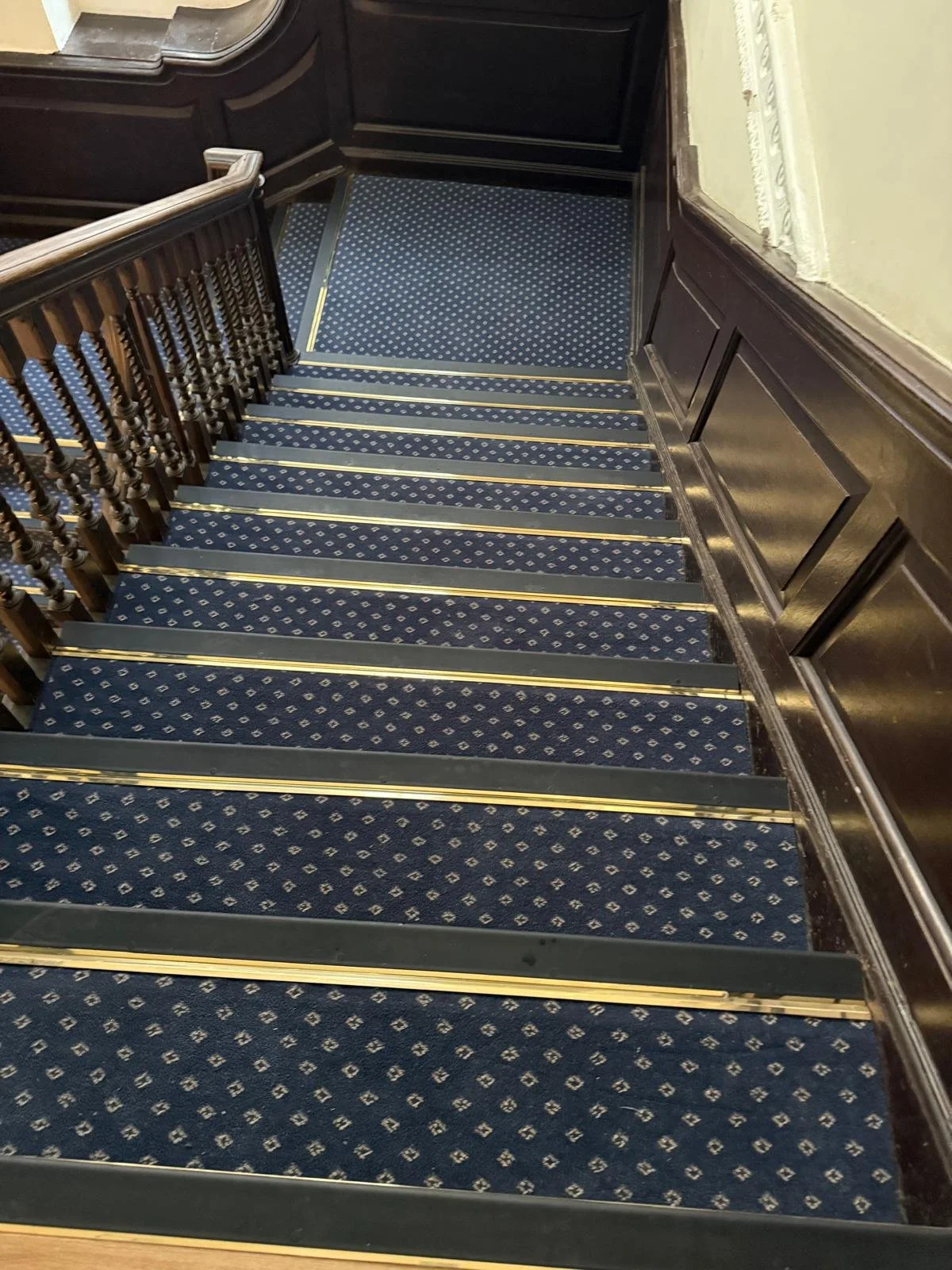 Solid bronze nosing installed with backtrack for carpet to be secured