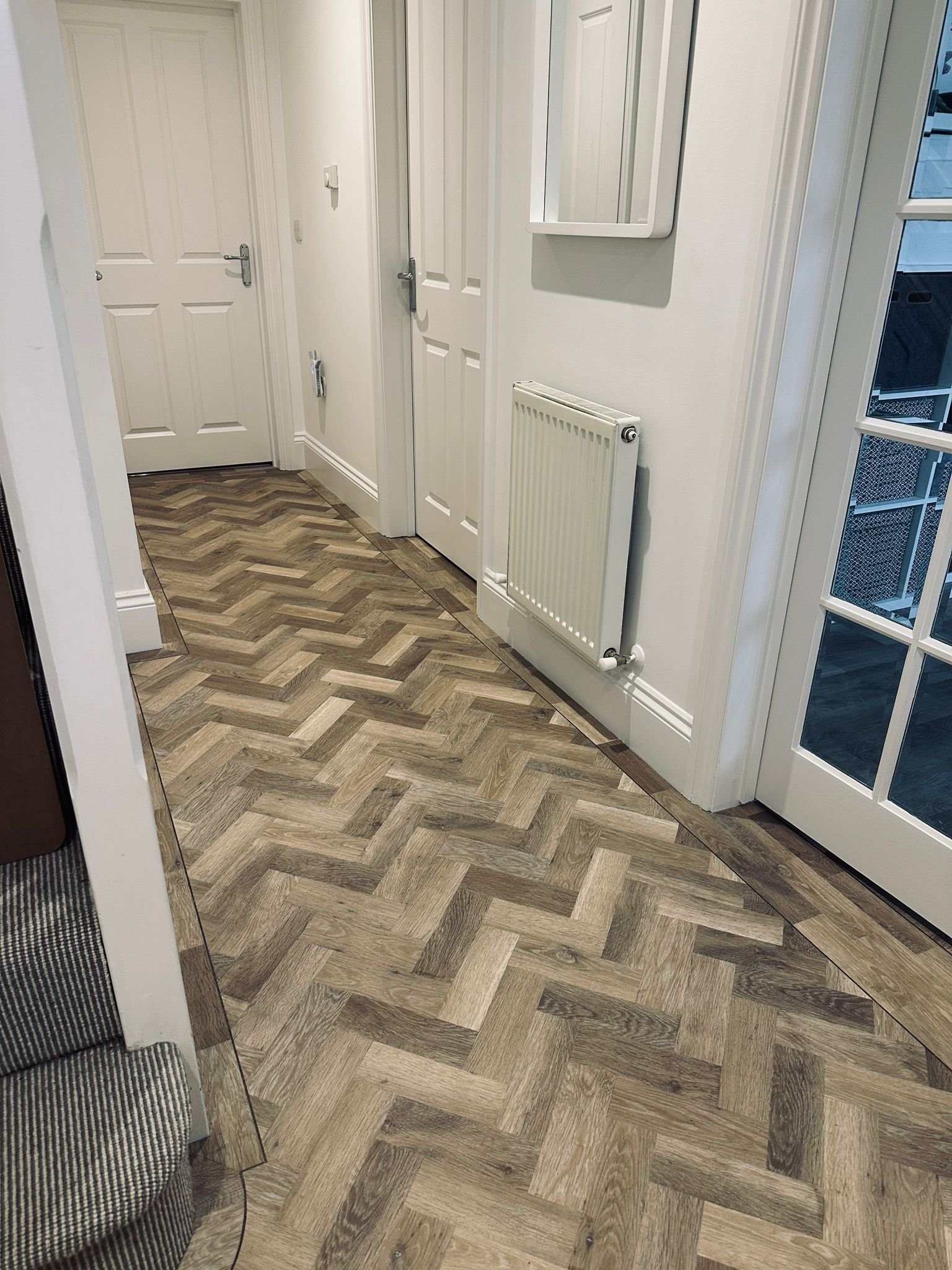 Entrance hall with Karndean Knight tile lime washed oak in a herringbone design with 3mm design strip to follow the perimeter