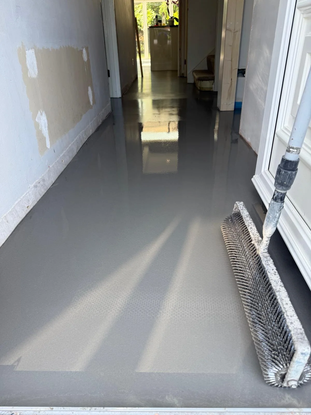 A freshly poured self levelling compound over underfloor heating ready for final flooring finish. by Fantastic Flooring