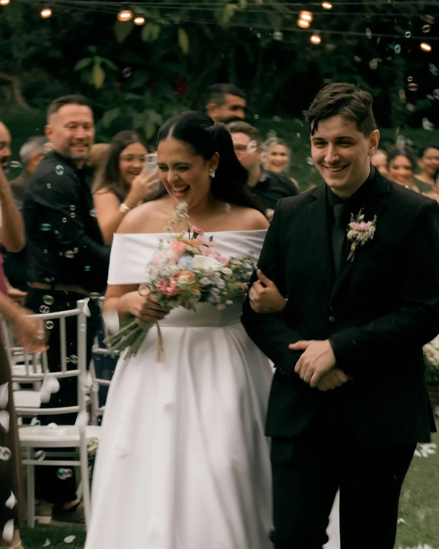 Newly weds walking down the aisle in beautiful English garden wedding.