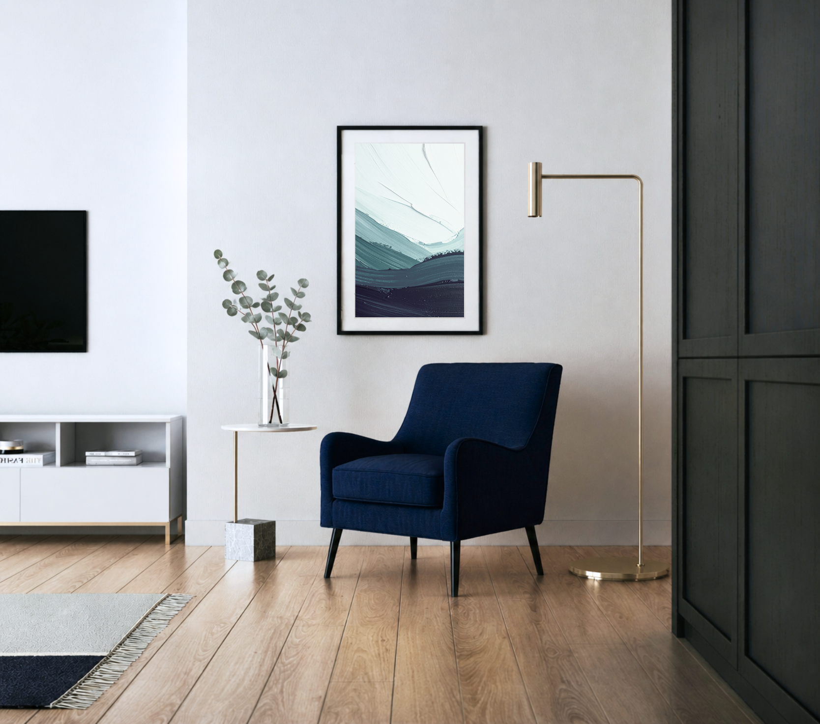 Modern living room with white wall, abstract landscape art, dark blue armchair, white TV stand, potted eucalyptus, gold floor lamp, wooden flooring, and a black cabinet.