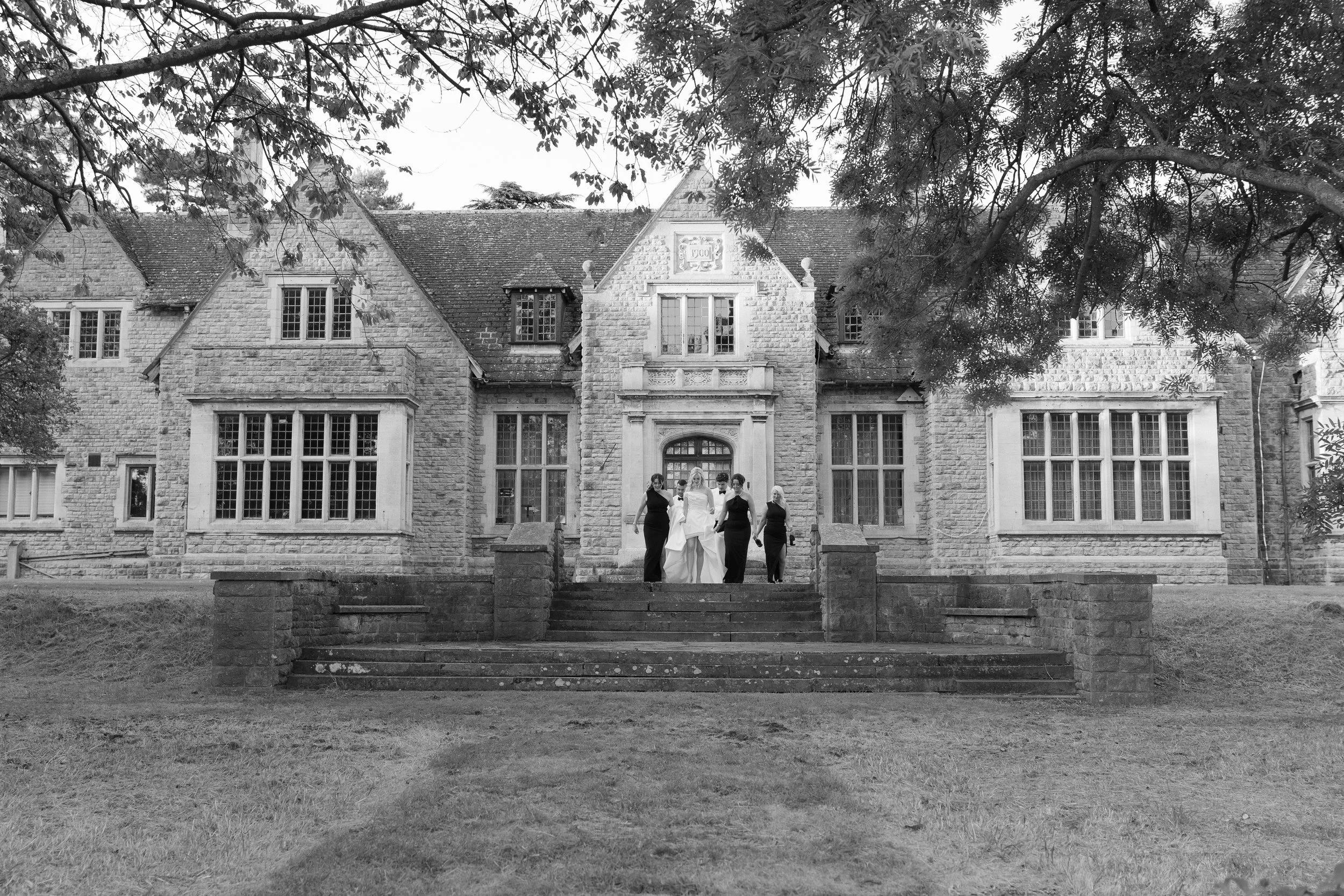 image of group walking down stairs in black tie