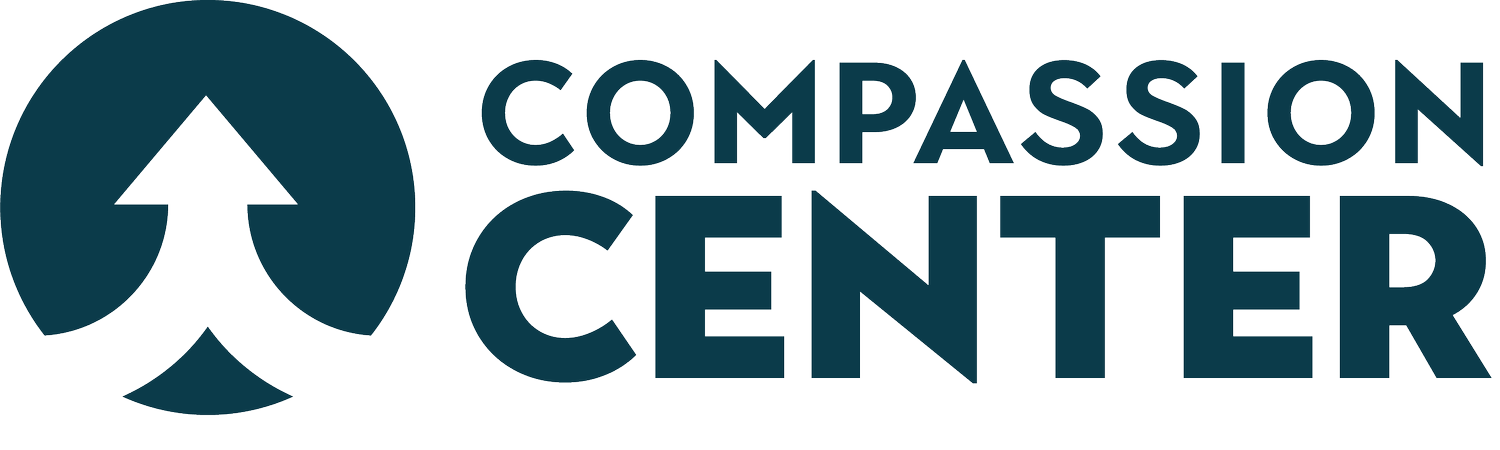 Logo of Compassion Center with a stylized leaf and upward arrow within a circle, and the words "Compassion Center" next to it.