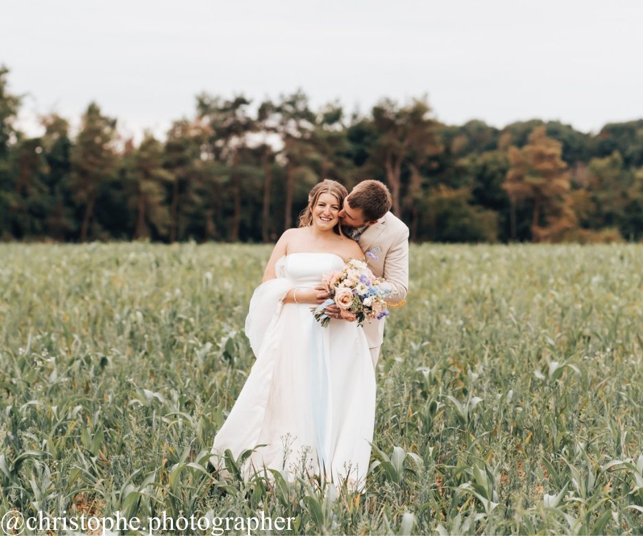 Bride and groom in field