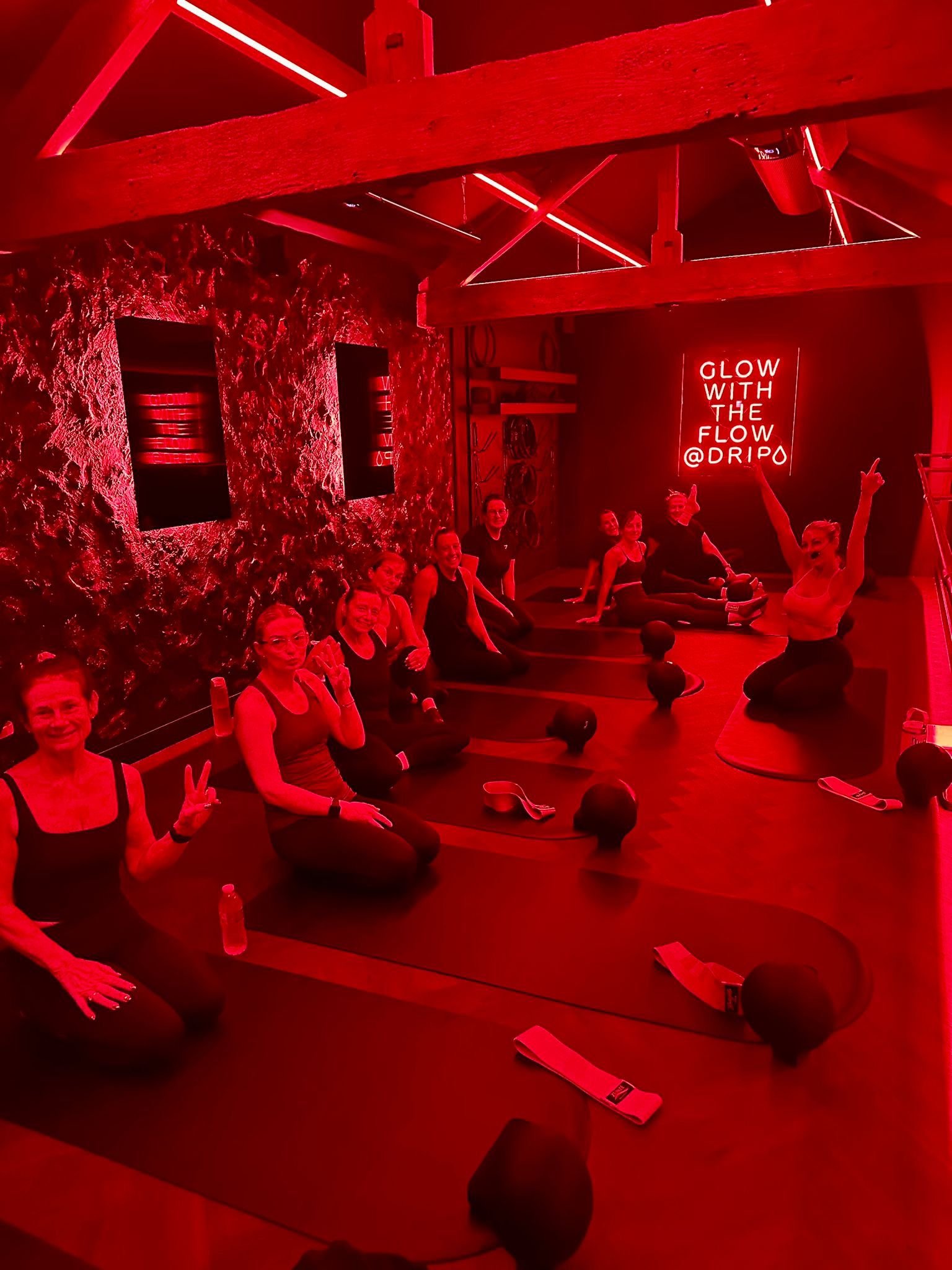 women  in the Drip Studio in Blackpool, with a red workout sign in the background.
