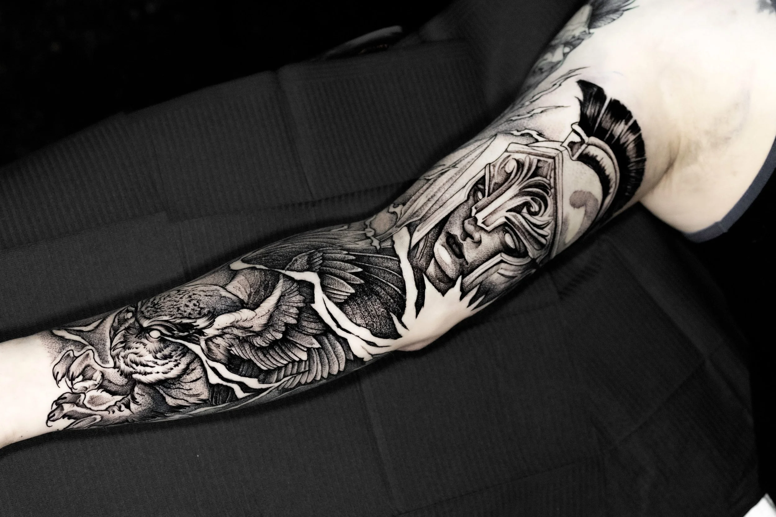 Black-and-gray female warrior and eagle arm tattoo.