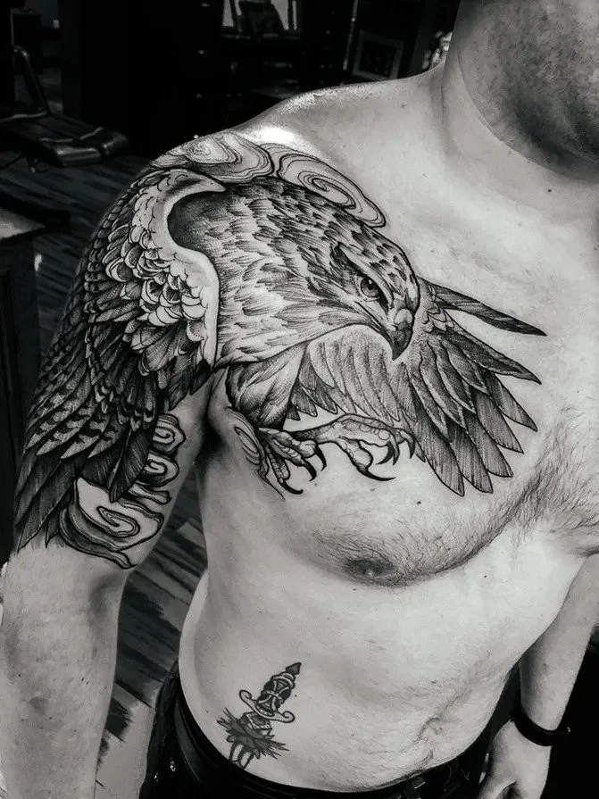 Black-and-gray hawk chest and shoulder tattoo.