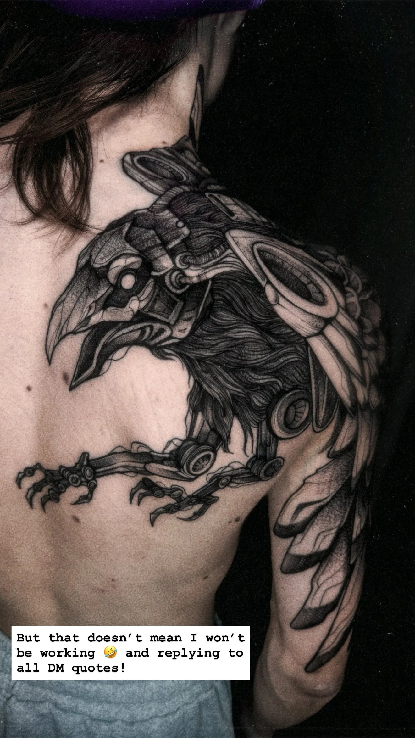 A detailed black-and-grey tattoo on a person's shoulder and upper back featuring a "cybernetic" raven with mechanical joints, wires, and armor plates integrated into its feathers.