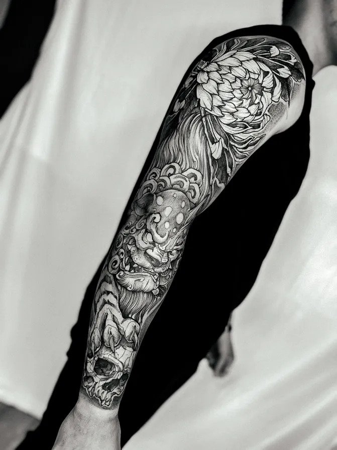 Black-and-gray traditional Asian sleeve tattoo.